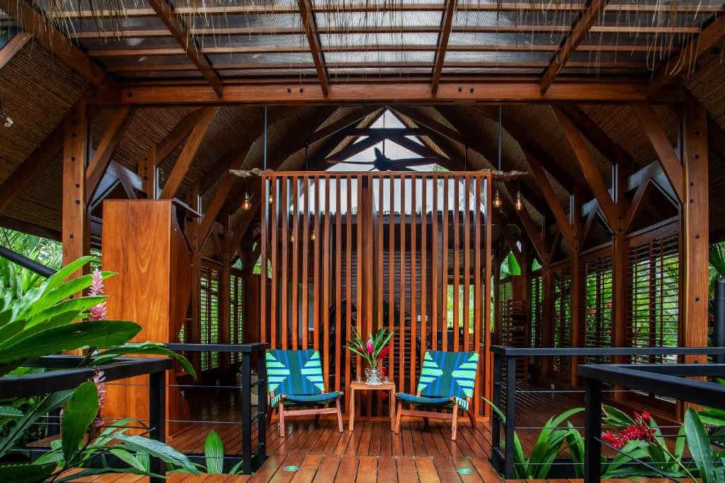 Two colorful chairs under a wooden pergola