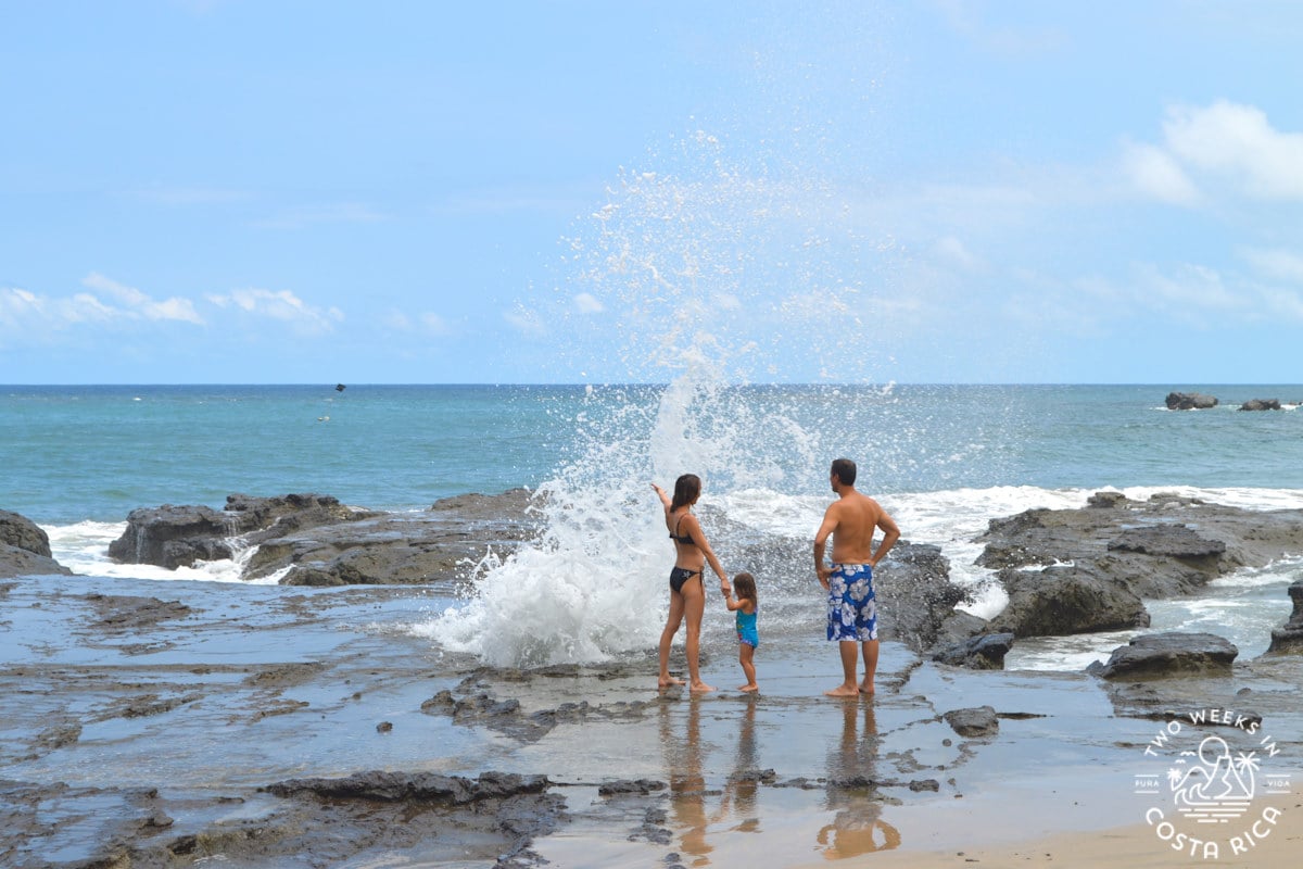 a family at the blowhole at Playa Pelada, Nosara