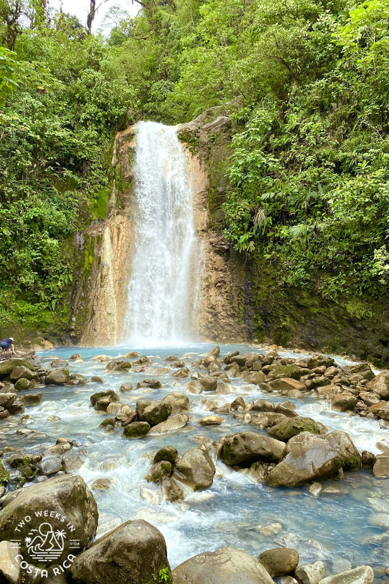 a waterfall with blue water and rocky river