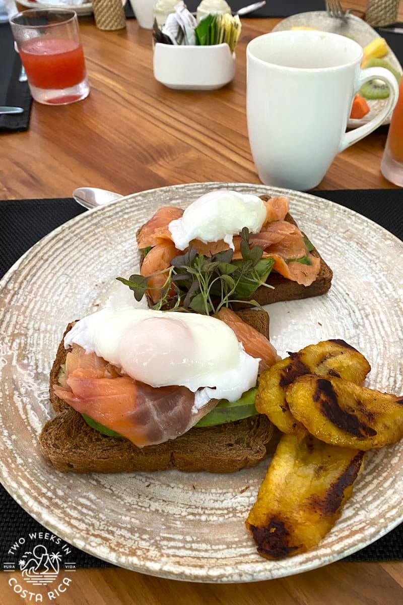 a plate with toasts of salom and eggs with plantains