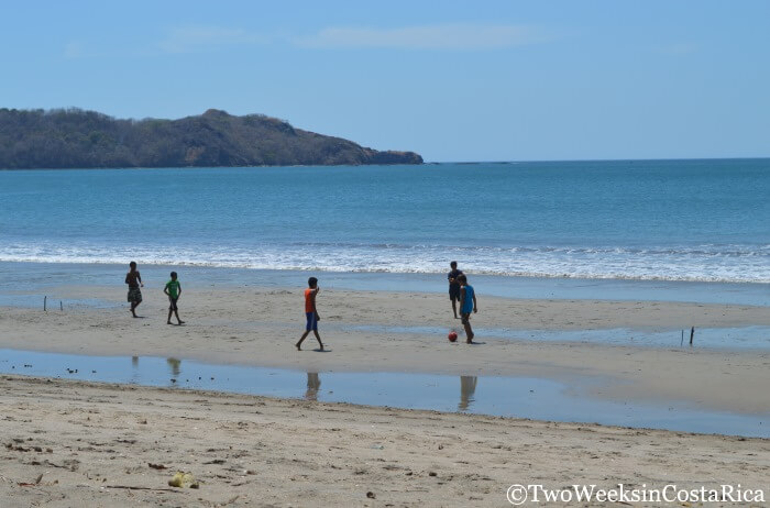 Kids playing soccer on the beach in the authentic town of Playa Brasilito in Guanacaste