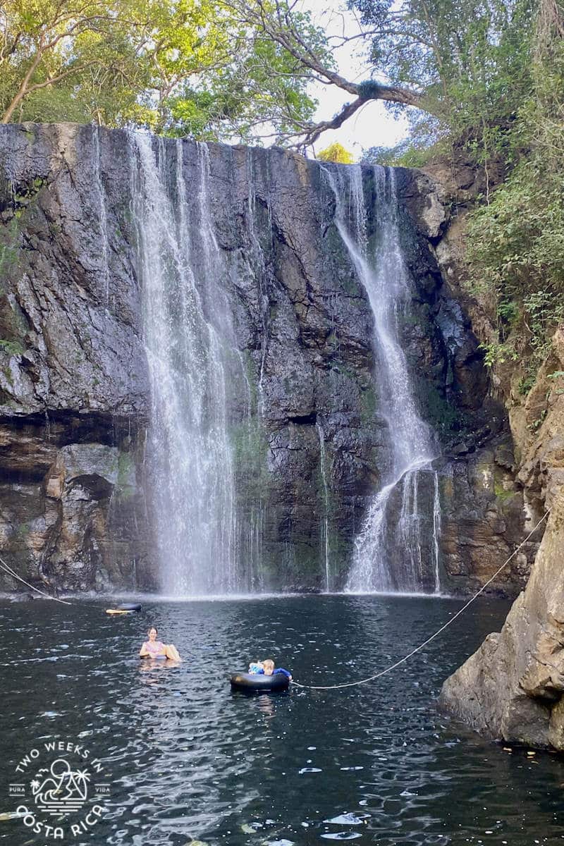 people floating in tubes at a waterfall in costa rica