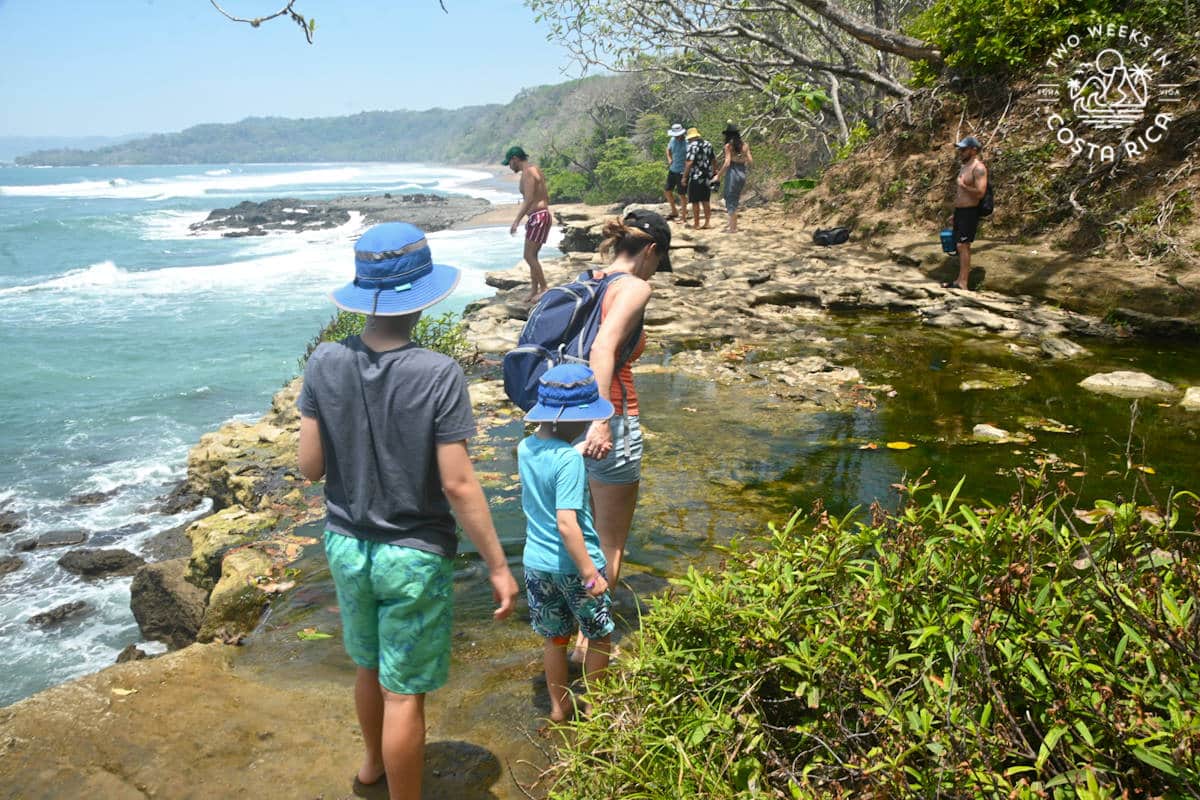 a family crossing the river of catarata el chorro