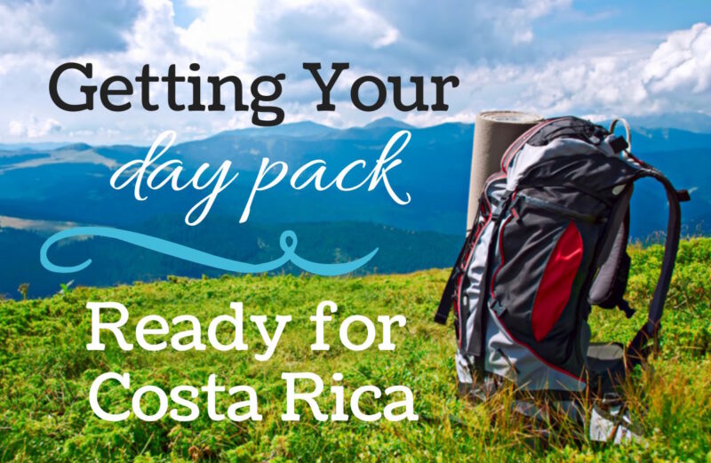 a backpack on the grass with mountains in the distance and text that reads getting your daypack ready for costa rica