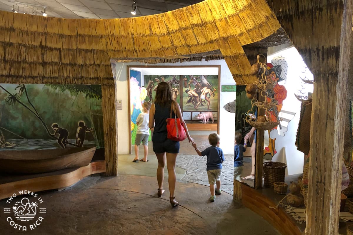 a family walking through an exhibit at the costa rica children's museum