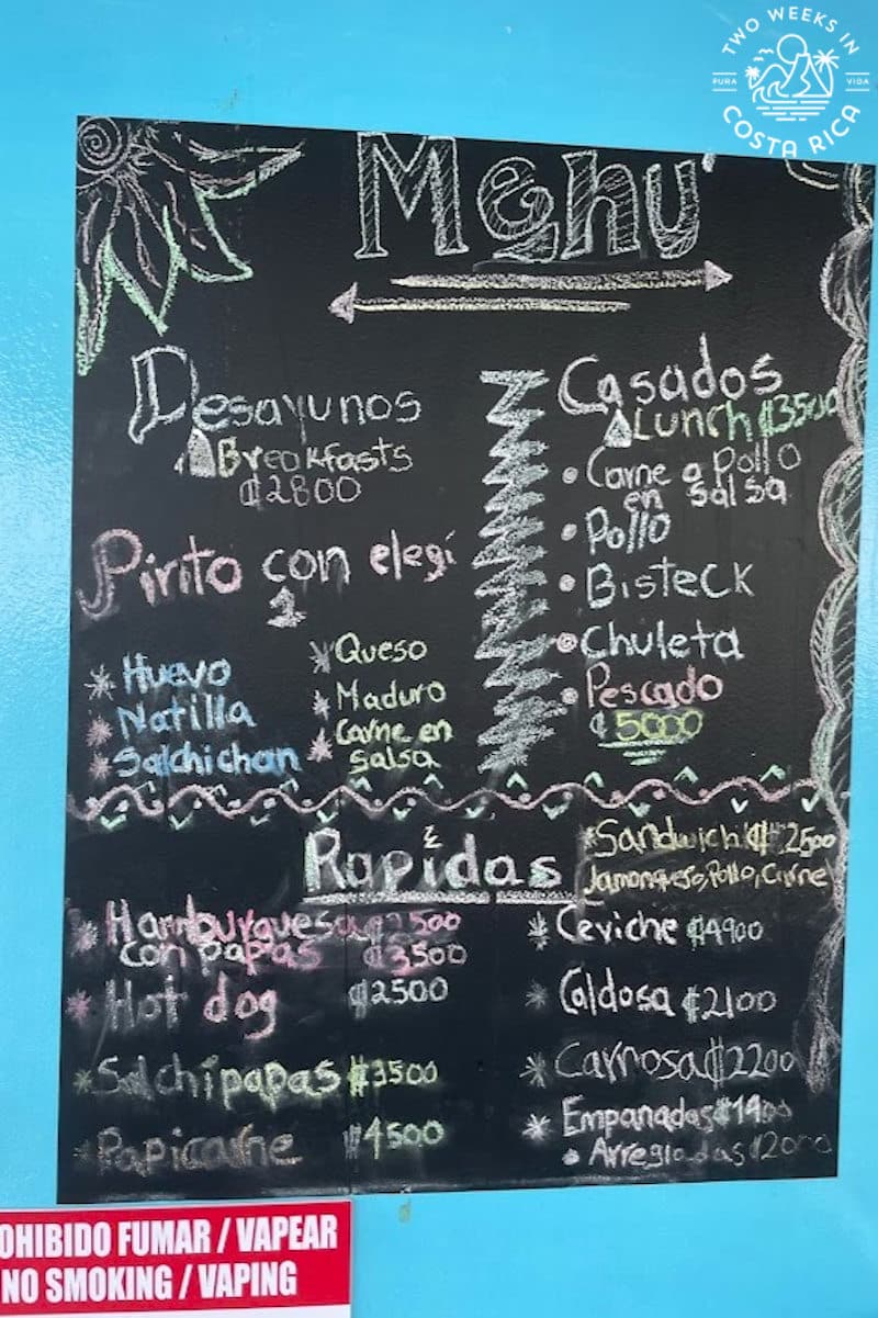 A chalkboard menu with a list of local dishes available for purchase on the Puntarenas ferry in Costa Rica