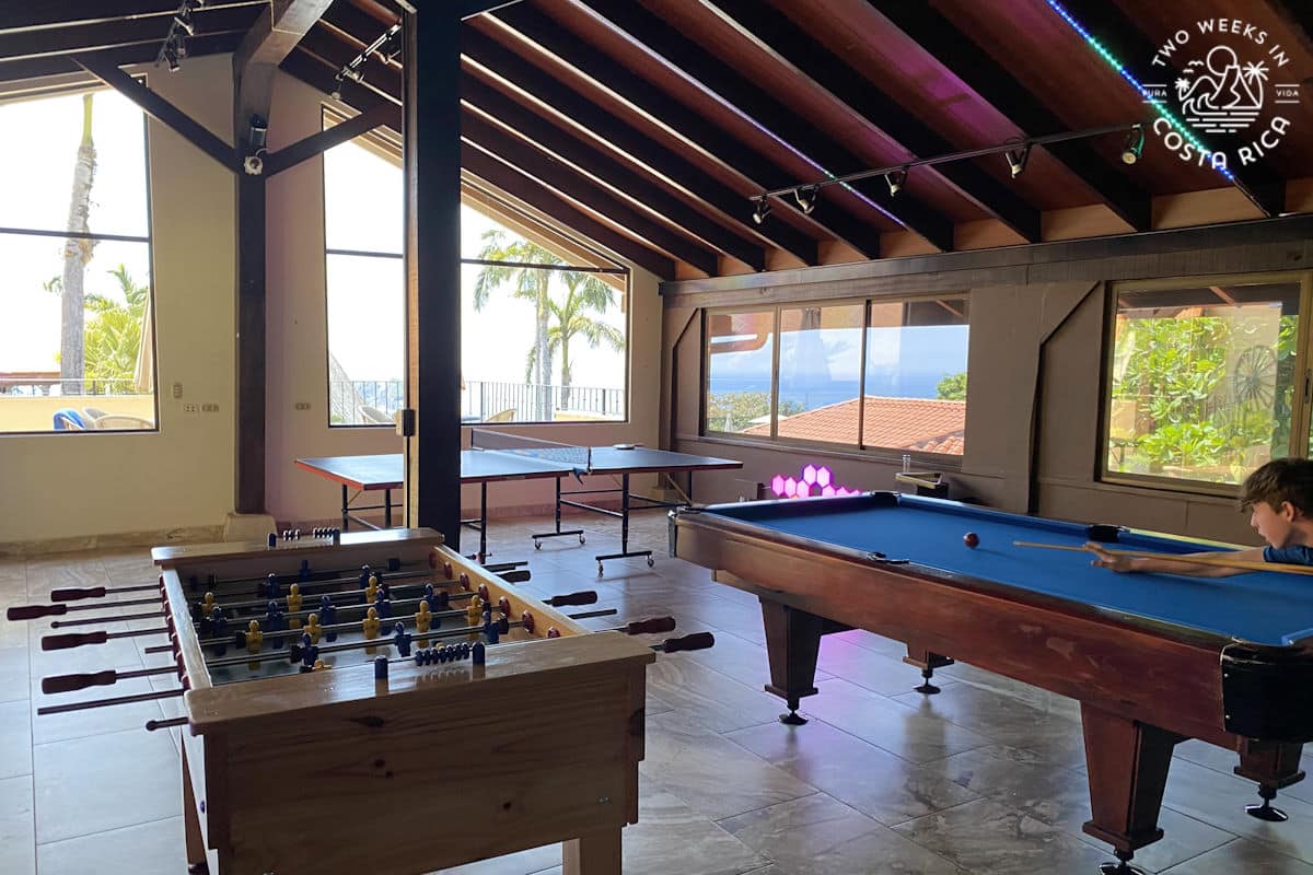 room with pool table and foos ball