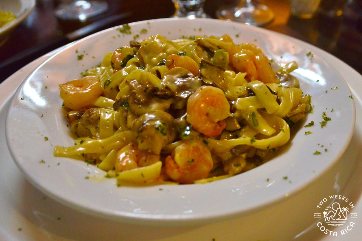 a plate with pasta and shrimp at a restaurant in Monteverde Costa Rica