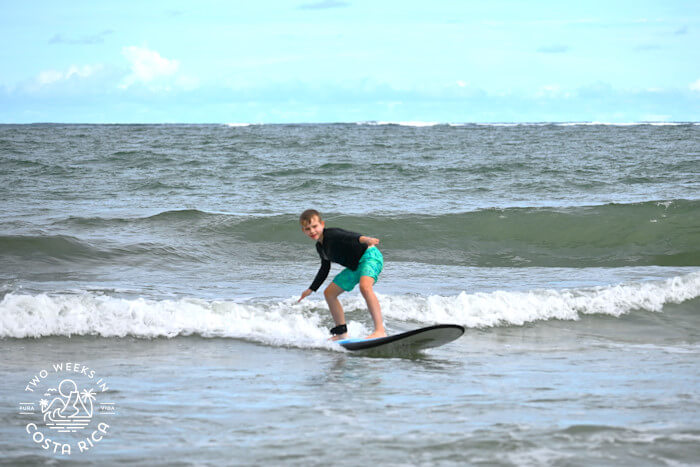 a kid surfing in white water