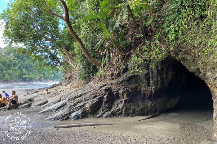 people sitting outside the main cave at Playa Ventanas