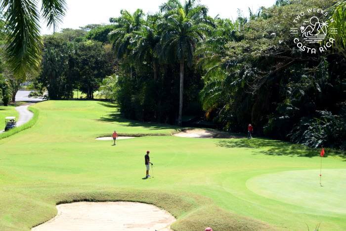 People playing golf at the golf course at Los Delfines Condos