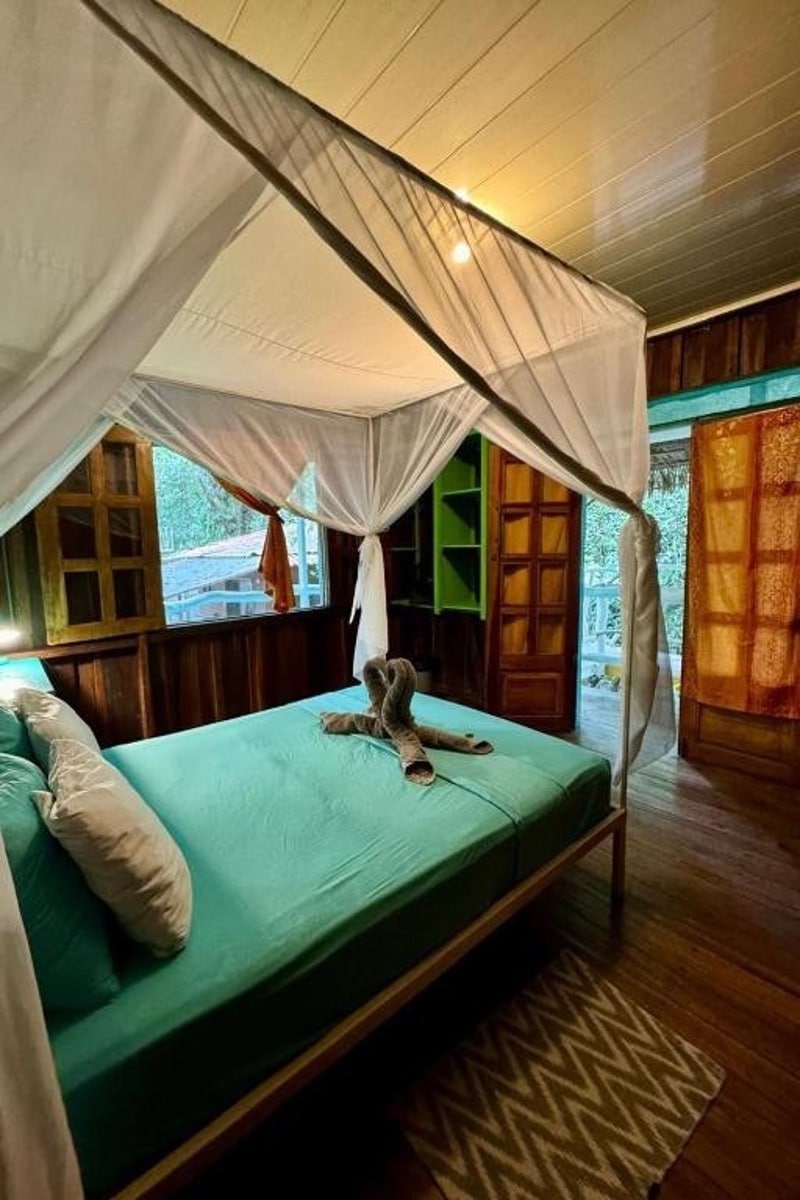 room with a bug net at Madre Selva Hostel in Puerto Viejo