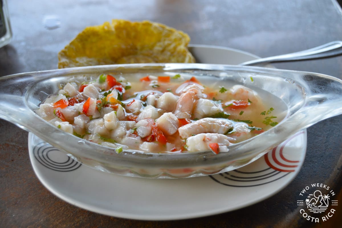long skinny glass dish with white fish and chopped peppers