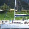 close up of catamaran sailboat with people on it