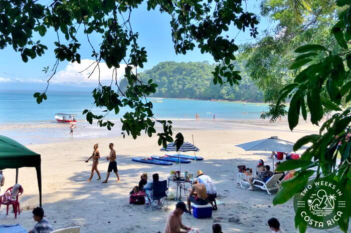 People gathered in the shade at Playa Mantas