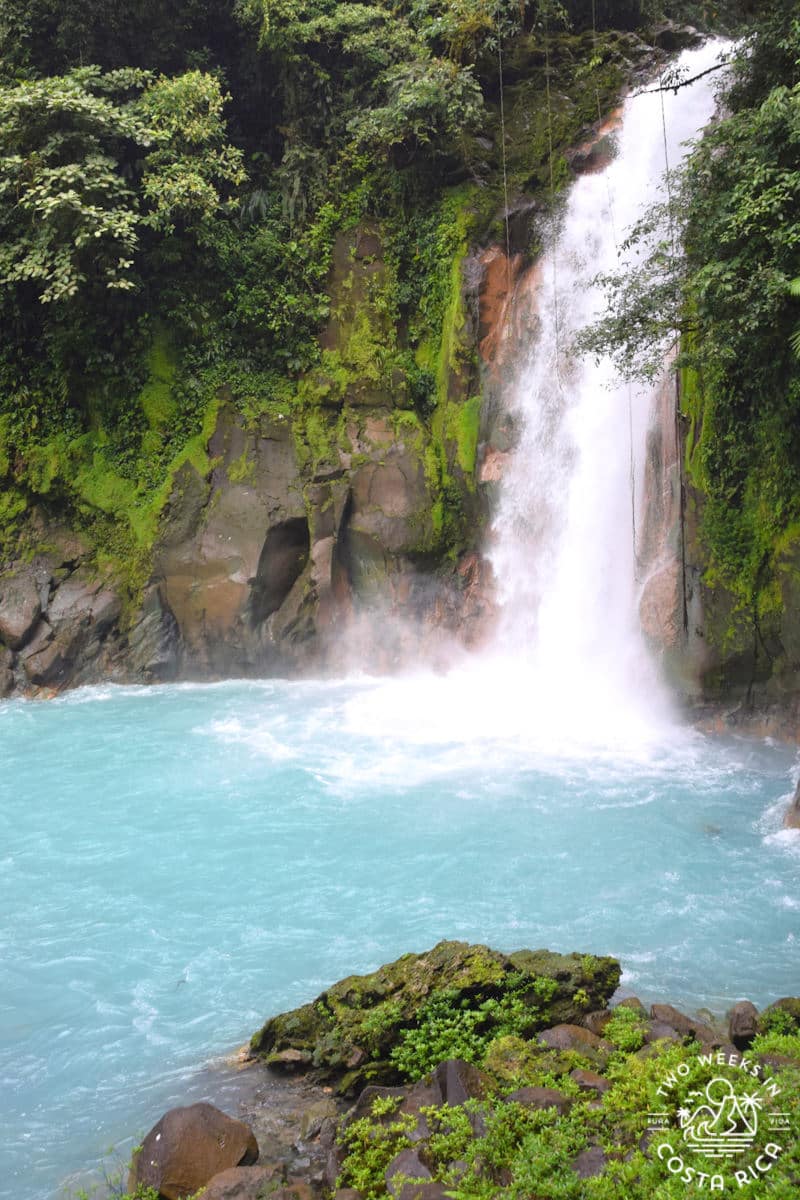 waterfall flowing into a blue pool of water