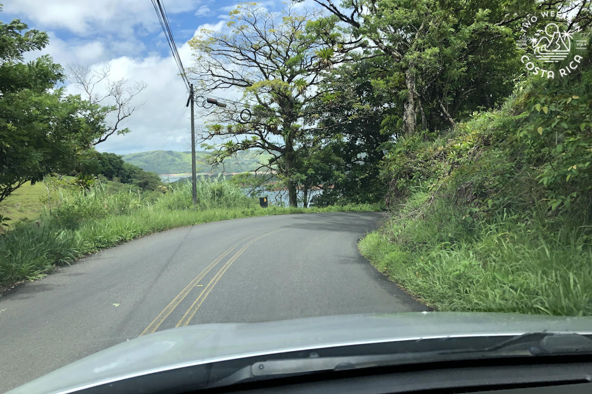 View through the windshield of a curvy and narrow road