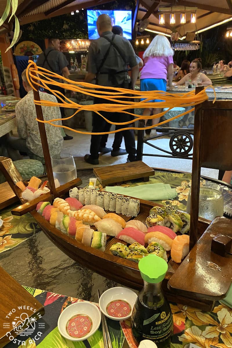 small wooden boat plate with pieces of sushi