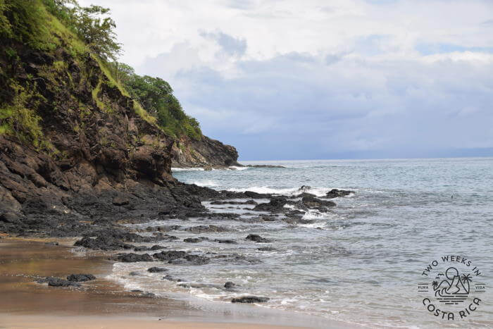 a rocky point at the end of the beach