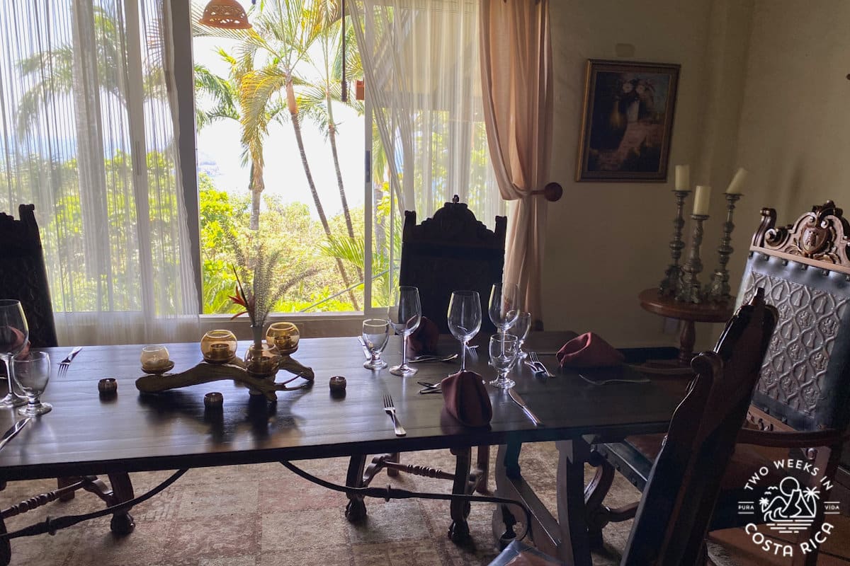 dining table decorated with candlesticks and ornate objects