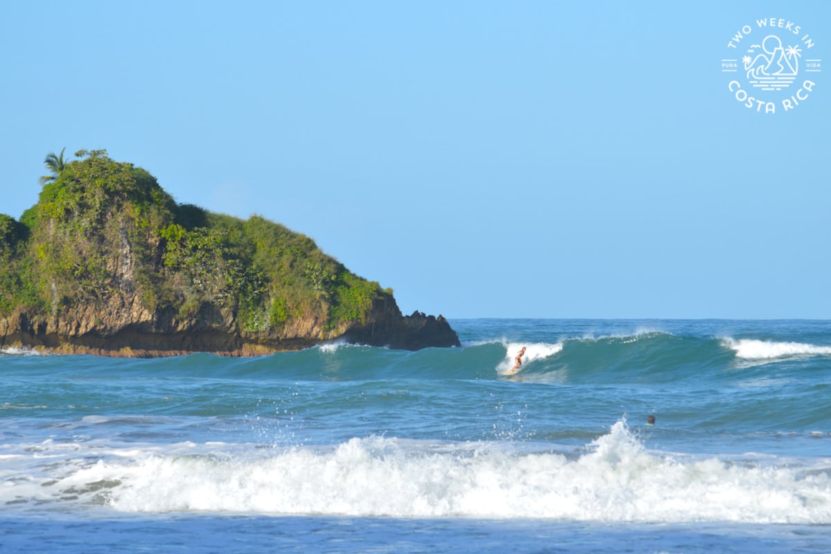 a woman surfing a big wave at playa cocles near puerto viejo