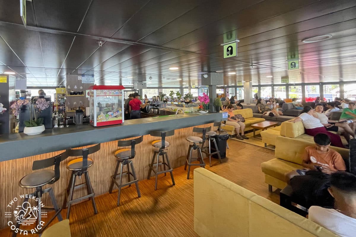 Inside view of the Tambor IV Ferry in Costa Rica showing seating and a bar