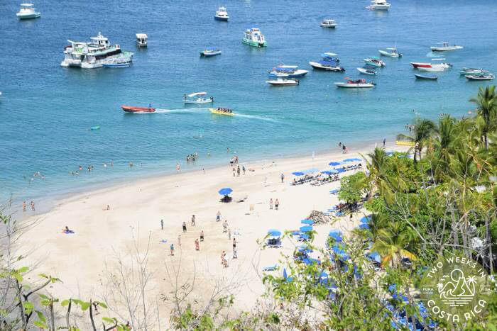 view of Tortuga Island from above showing white sand beach and boats