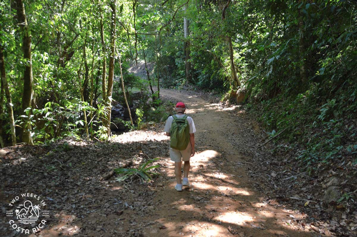 a man walking along the dirt trail to nauyaca waterfalls