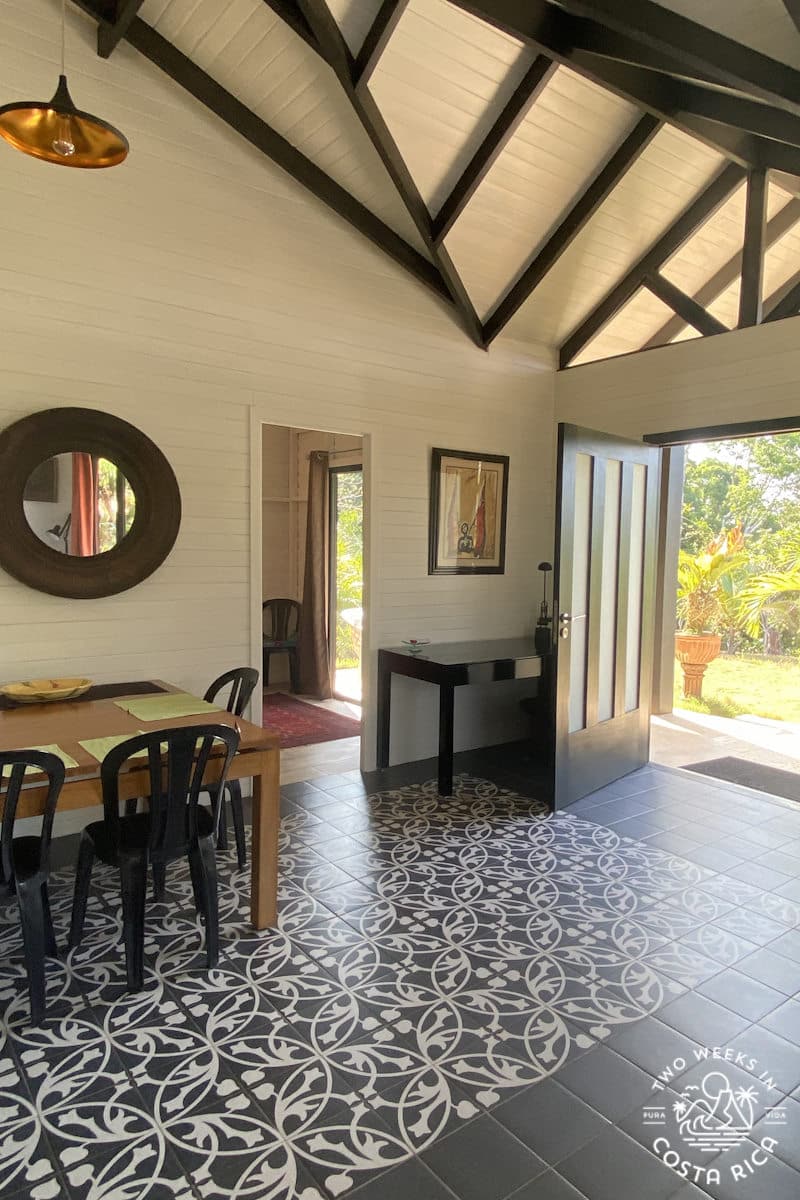 a room with high ceilings and the front door open