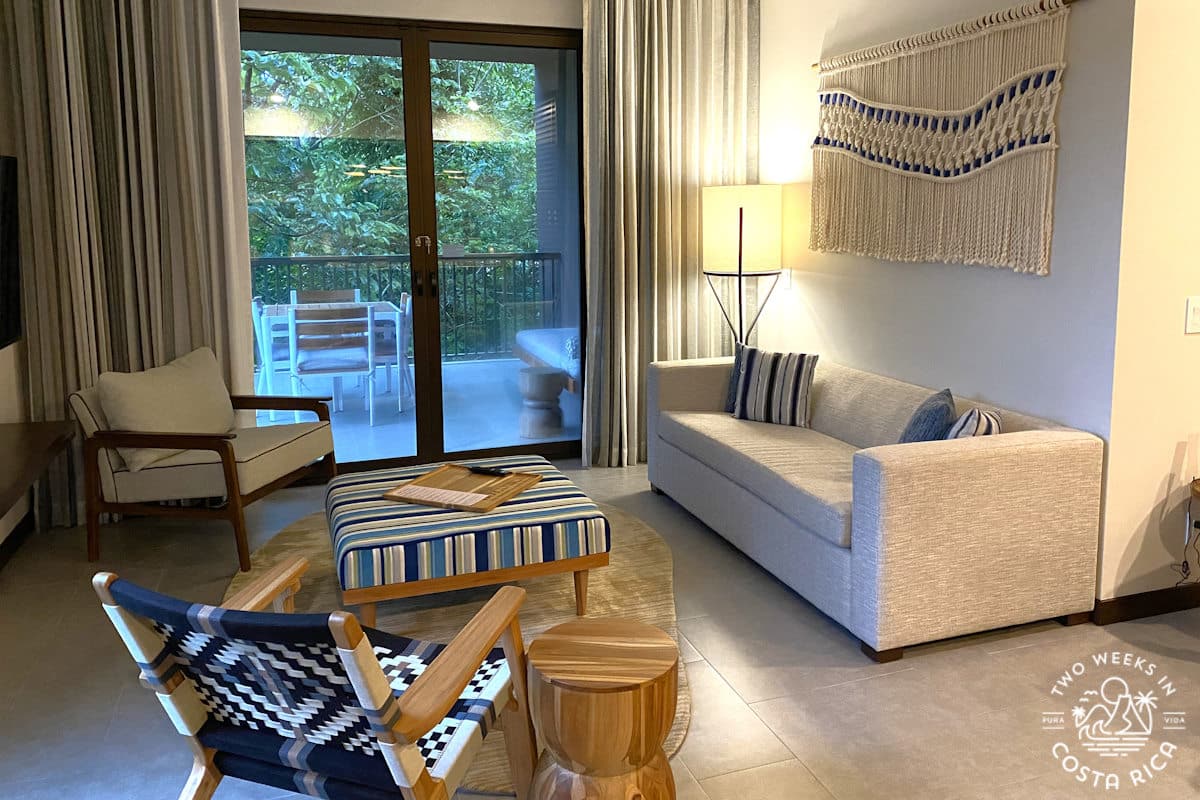 a room with a couch chair and modern furniture with a balcony